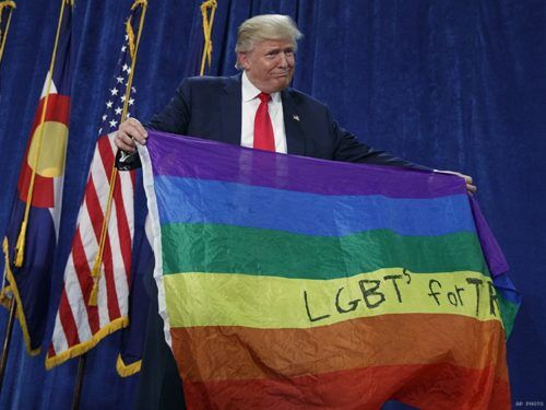 donald trump holds up gay flag