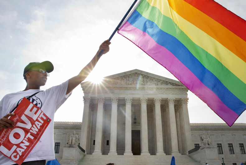 Carlos McKnight Carlos McKnight of Washington, waves a flag in support of gay marriage outside of the Supreme Court in Washington, Friday June 26, 2015.