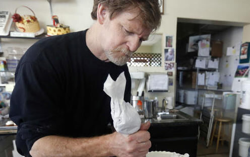 In this March 10, 2014, file photo, Masterpiece Cakeshop owner Jack Phillips decorates a cake inside his store in Lakewood, Colorado.