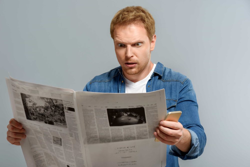 man surprised newspaper