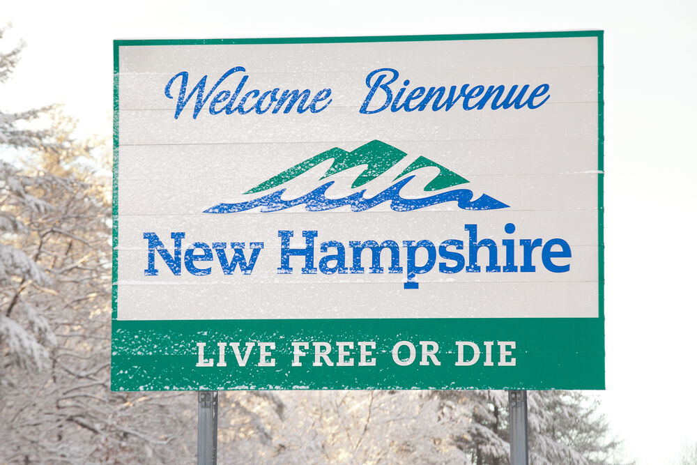 Welcome sign for New Hampshire is covered with fresh fallen snow on February 5, 2016 in Nashua, NH.