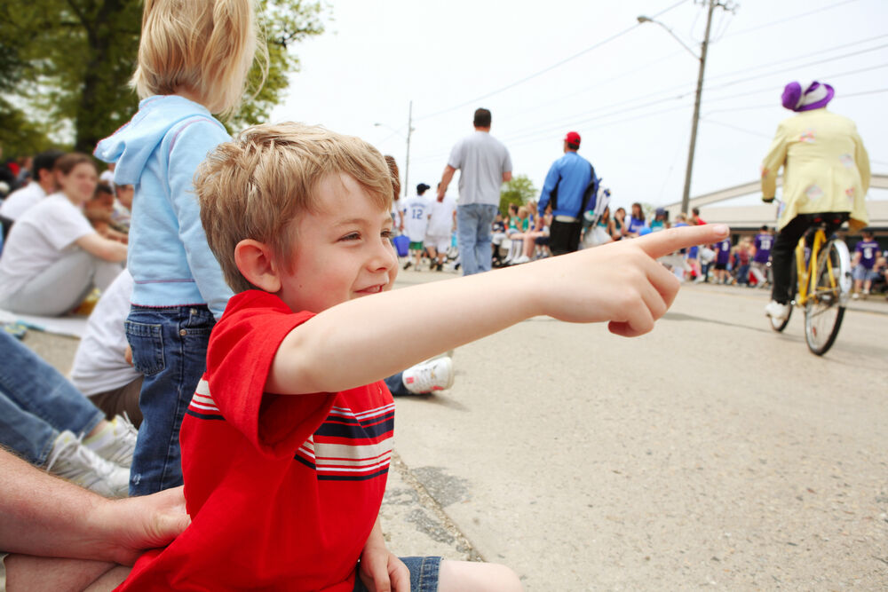 A boy watches a parade go by