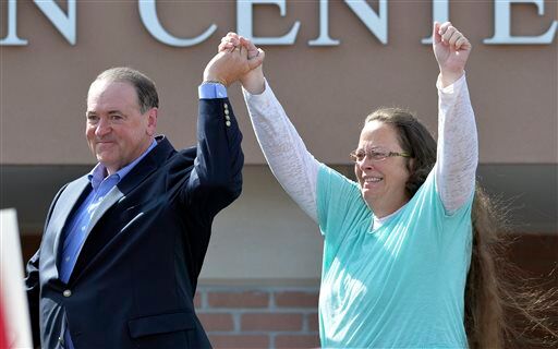 FILE - In this Sept. 8, 2015, file photo, Rowan County Clerk Kim Davis, with Republican presidential candidate Mike Huckabee at her side, greets the crowd after being released from the Carter County Detention Center, in Grayson, Ky. Davis, hauled to jail for defying a series of federal court orders and refusing to issue marriage licenses to same-sex couples, filed a 40-page court document Thursday, Sept. 24, blaming Kentucky governor Steve Beshear for all her legal woes.