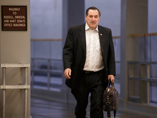 FILE - In this Friday, Feb. 3, 2017, file photo, Sen. Joe Donnelly, D-Ind., arrives early on Capitol Hill in Washington. Donnelly says he'll support the nomination of Judge Neil Gorsuch to the U.S. Supreme Court. The Indiana Democrat announced his support on Sunday, April 2, 2017, for President Donald Trump’s pick, calling Gorsuch "a qualified jurist who will base his decisions on his understanding of the law and is well-respected among his peers." Donnelly faces a tough re-election in 2018.