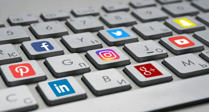 A computer keyboard with keys depicting social media platform logos.