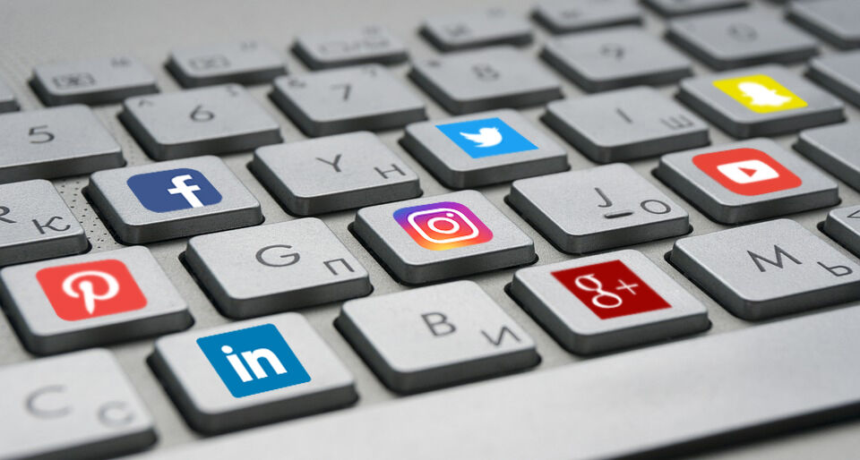 Keyboard with various logos of social media platforms on it