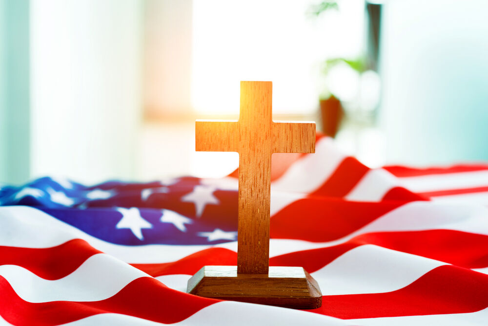 cross on top of an American flag