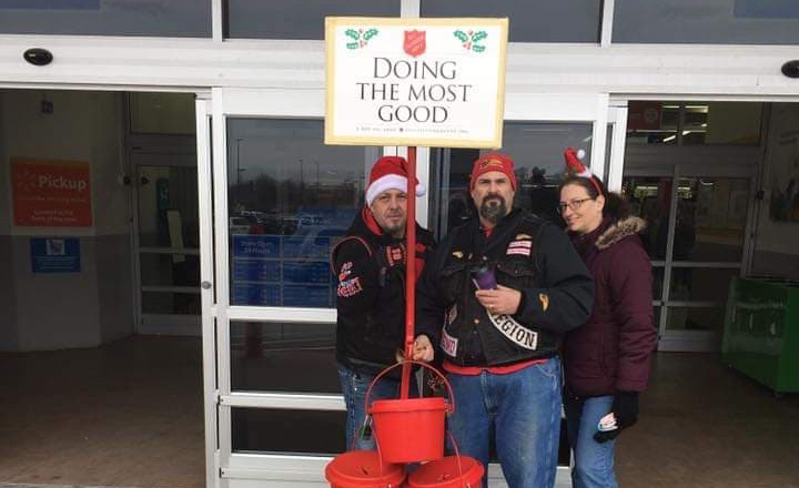 Members of the Hells Angels Northwest Indiana Region Motorcycle Club stand behind the Salvation Army's iconic red kettle.