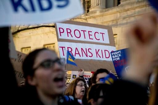 Activists and protesters with the National Center for Transgender Equality rally in front of the White House, Wednesday, Feb. 22, 2017, in Washington, after the Department of Education and the Justice Department announce plans to overturn the school guidance on protecting transgender students.