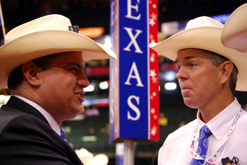 Texas delegates Rene Diaz (left) and David Barton (right) speak during the Republican National Convention at the Xcel Energy Center on September 3, 2008 in St. Paul, Minnesota.