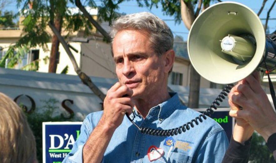 Ed Buck holding a megaphone