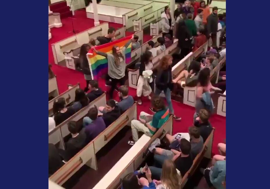 Students waved a rainbow flag as they walked out en masse to protest Jeff Sessions’ speech