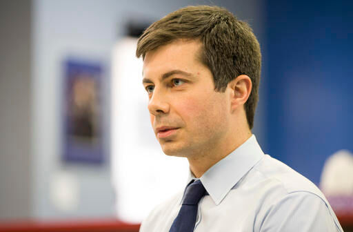 In this Wednesday, Jan. 4, 2017 photo, South Bend, Ind., Mayor Pete Buttigieg talks to a South Bend Tribune reporter regarding interest in the Democratic National Committee chairman position, inside the St. Joseph County Democratic Party headquarters in South Bend, Ind. Buttigieg announced his chairman candidacy Thursday, Jan. 5.