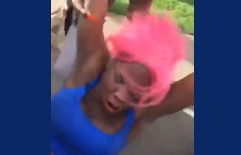 A transgender woman being dragged away