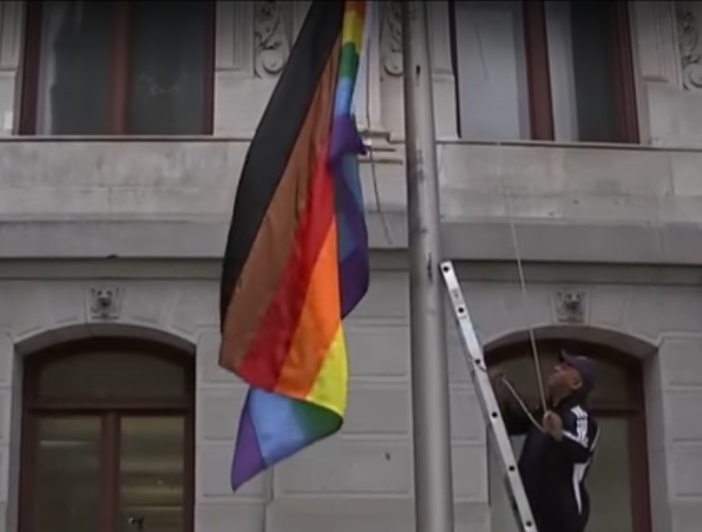 rainbow flag with brown and black stripes