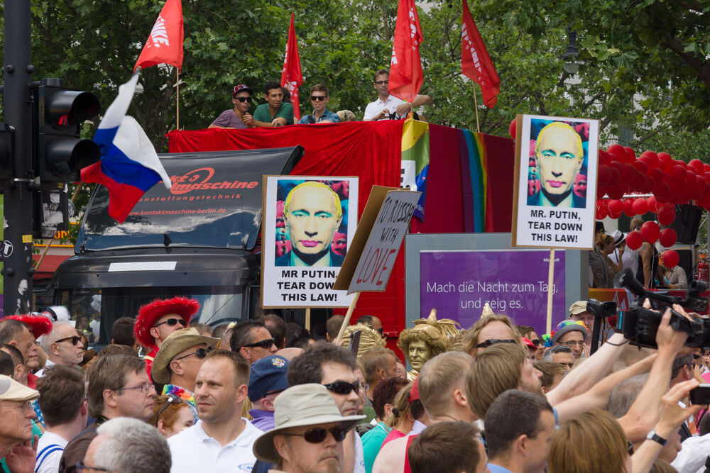 Demonstration of support for gays and lesbians of Russia against homophobic of the Act passed by the State Duma of the Russian Federation. Protestors hold Russian flags and signs showing Russian President Vladimir Putin's face covered in makeup