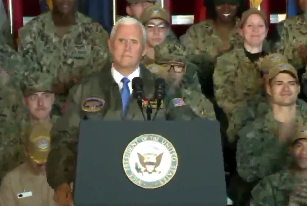 Mike Pence with applauding servicemembers behind him