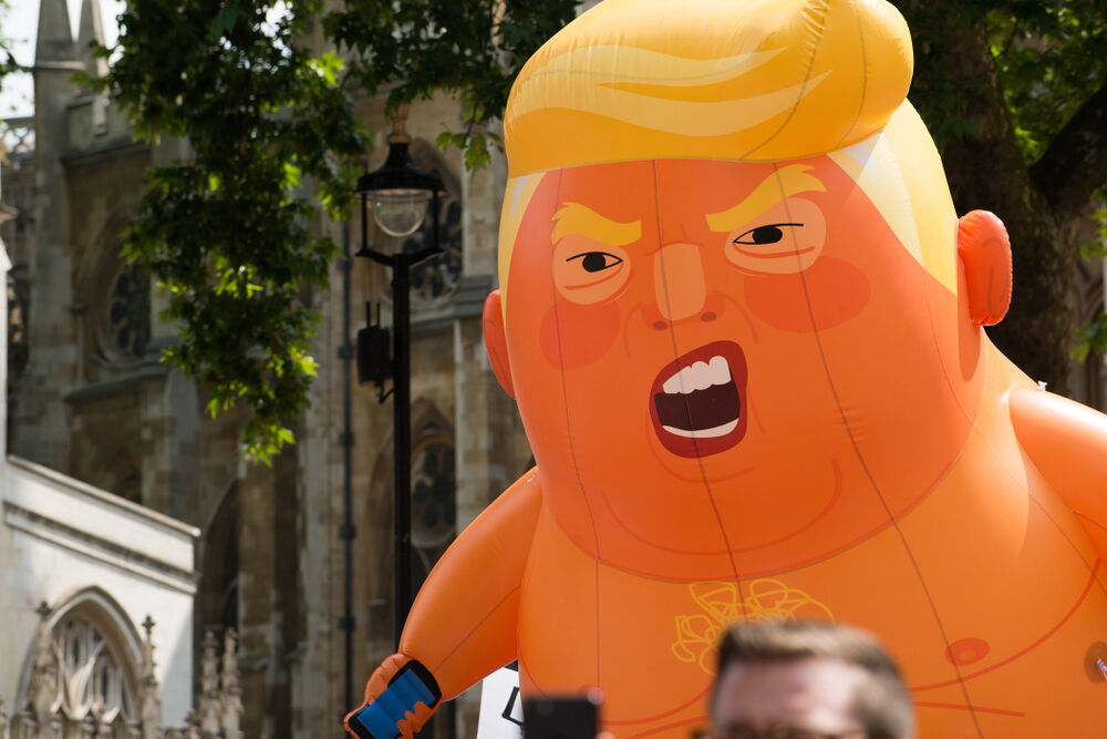 July 13, 2018: The orange Baby Trump blimp being paraded around Parliament Square, London, UK, at the #BringTheNoise Women's March demonstration.