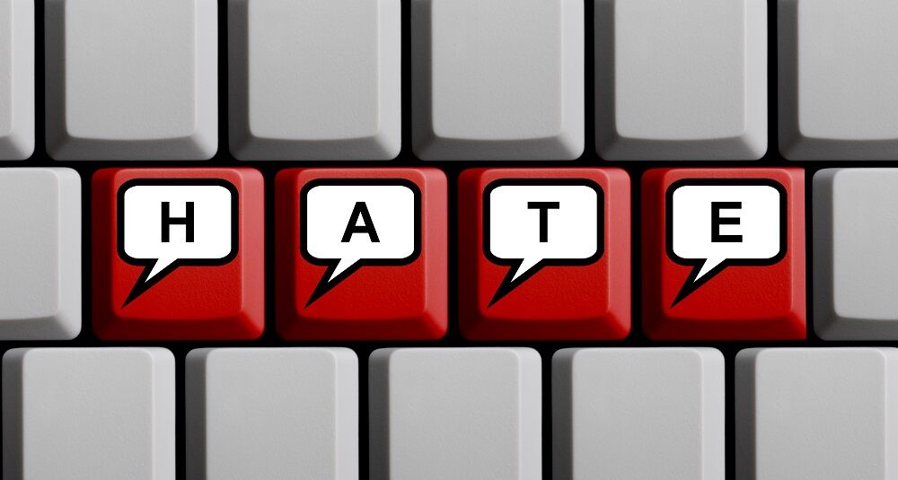 A keyboard with the word "HATE" spelled on it