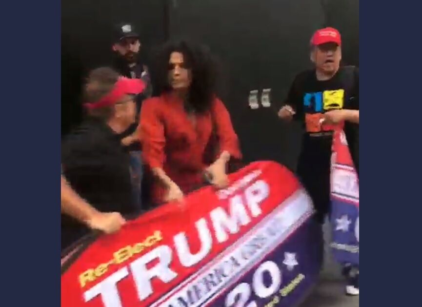 Indya Moore and the Trump supporter tugging the sign