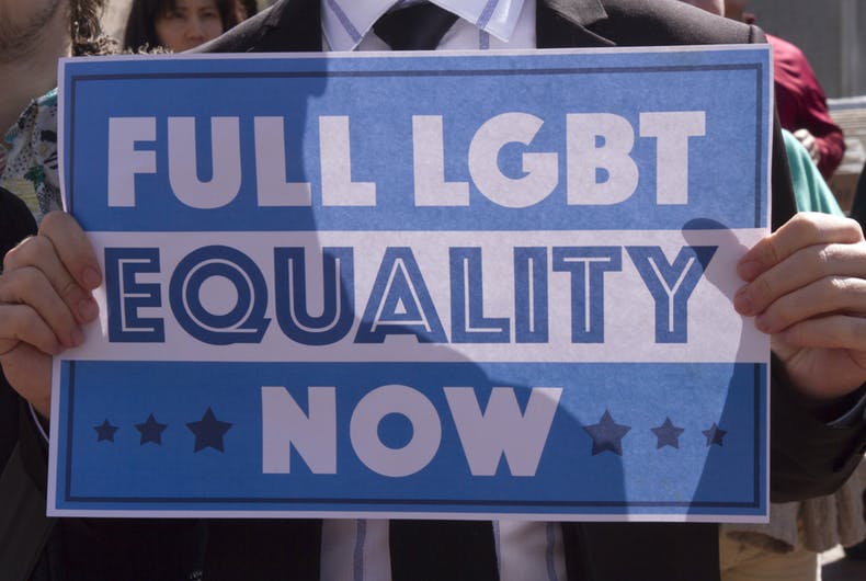 Asheville, North Carolina, USA - April 2, 2016: An activist holds a sign at a HB2 protest rally of a law that takes away the rights of the LGBTQ community.