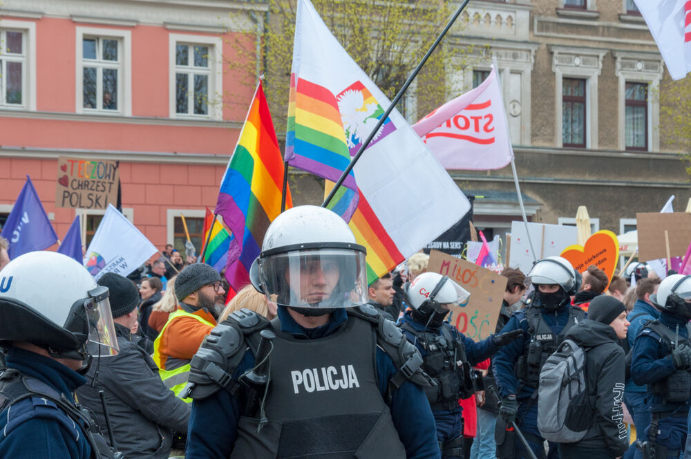Police stand guard as LGBTQ protesters march in Gniezno, Poland.