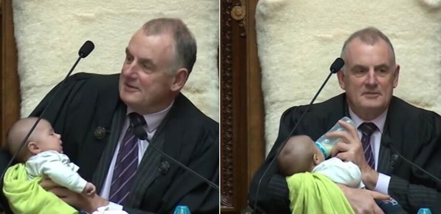 NZ Parliament Speaker Trevor Ballard holds 1-month-old Tutanekai Smith-Coffey, the son of MP Tamati Coffey and his husband, Tim Smith.