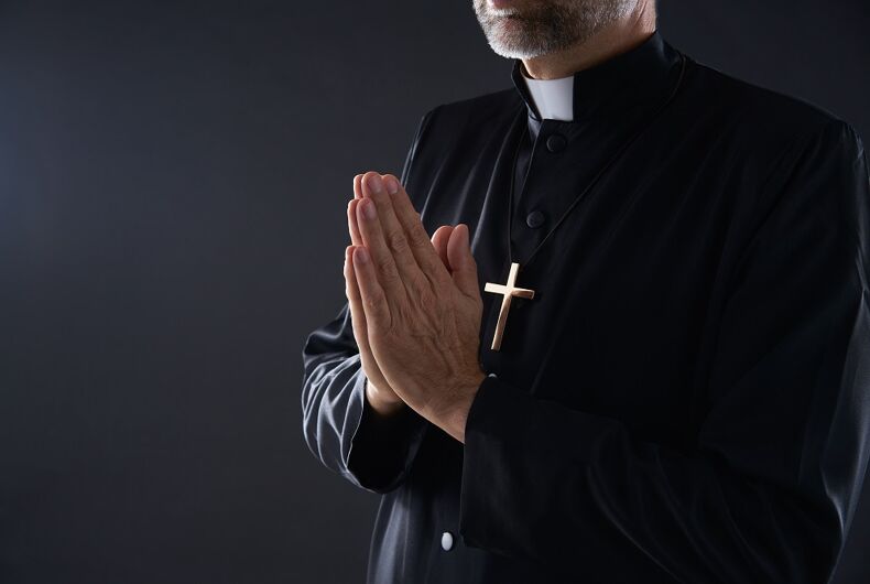 A dishy priest praying