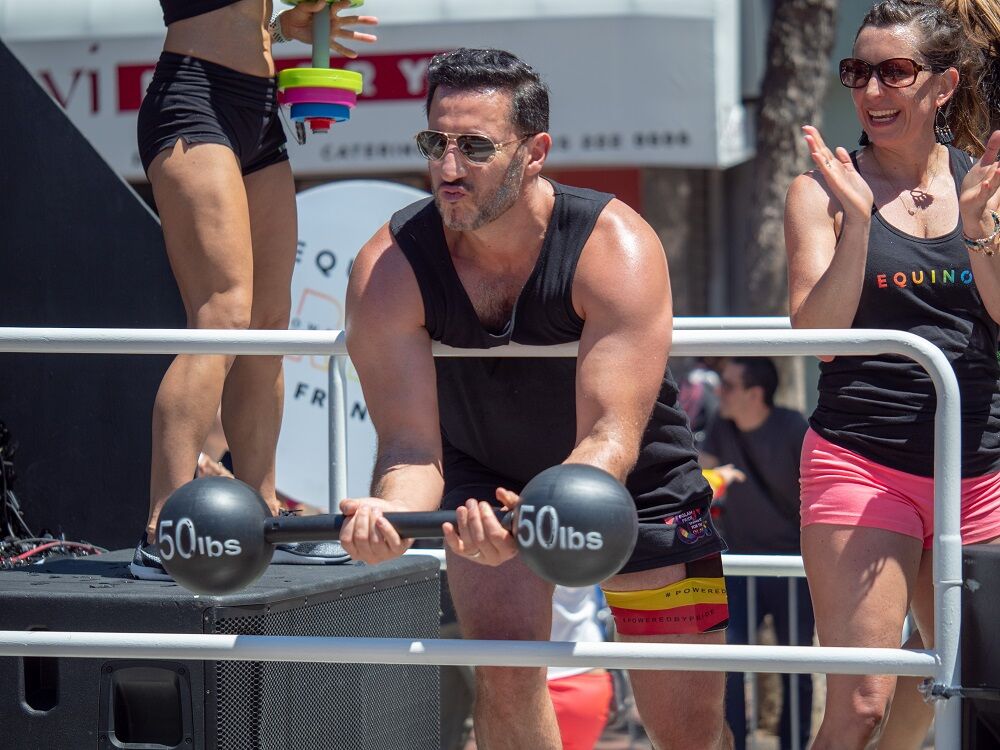 JUNE 23, 2018: Equinox employee lifting a mock 50 lb barbell during the San Francisco LGBT Pride Parade