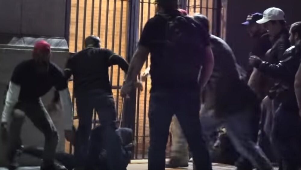A group of men beating someone