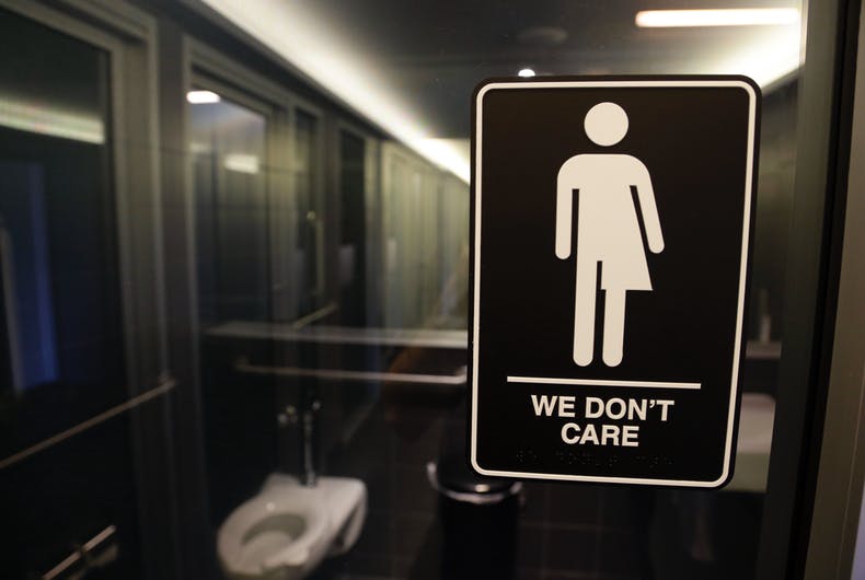 A "We don't Care" bathroom sign, with a bathroom in the background