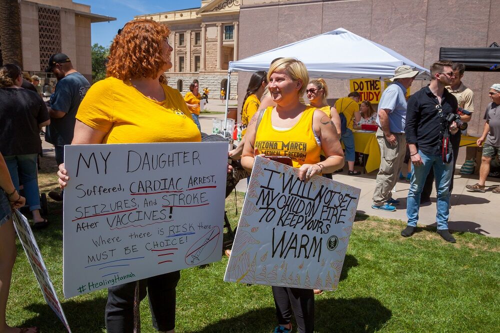 MAY 18, 2019: Two women holding signs at a demonstration against vaccinations in Arizona.