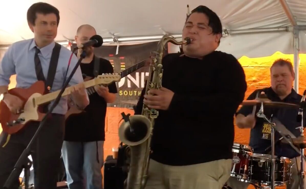 South Bend mayor Pete Buttigieg plays the guitar at a local neighborhood festival.