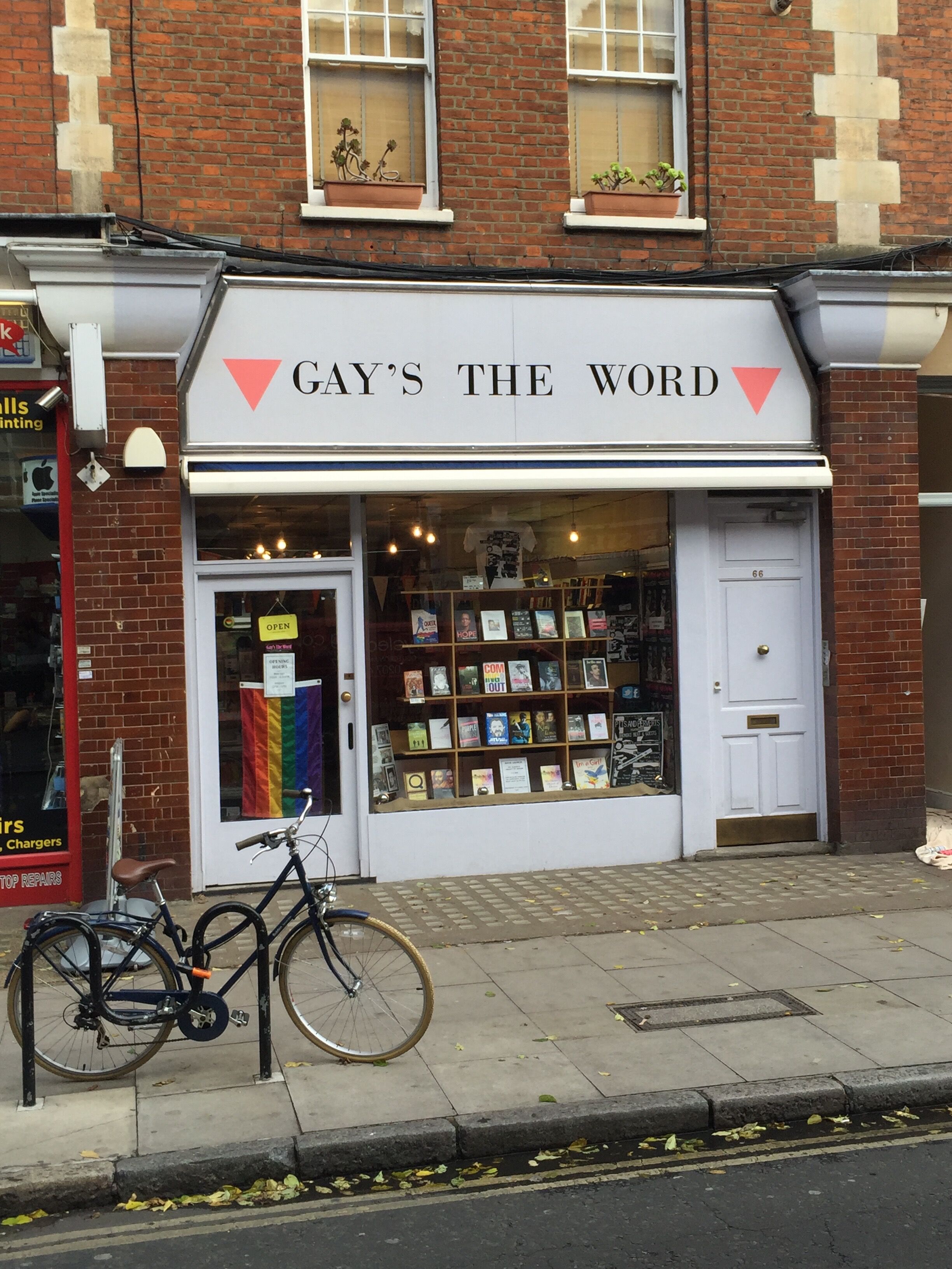 Gay's The Word is a gay bookstore whose sign has pink triangles and a rainbow flag in his glass front door.