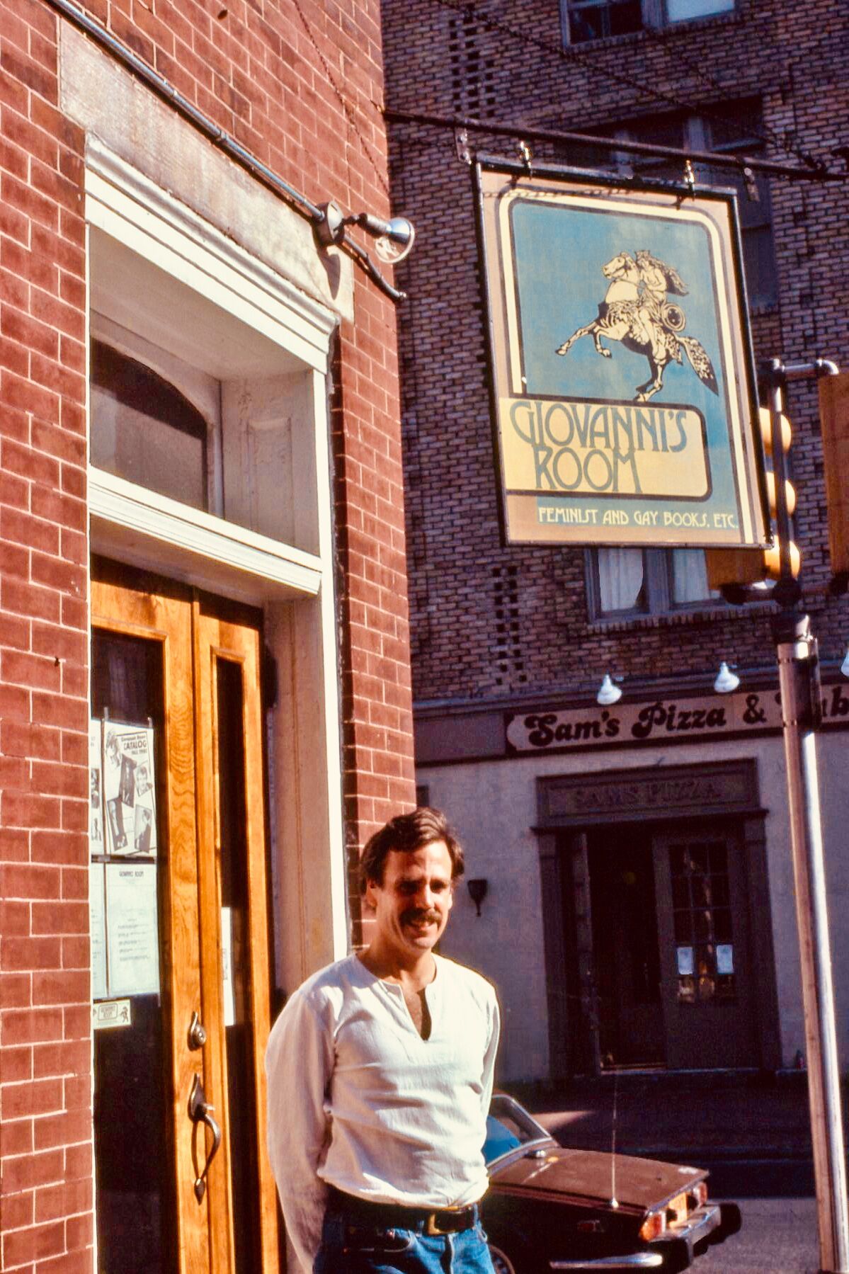 Ed Hermance standing in front of Giovanni’s Room in the 1980s.