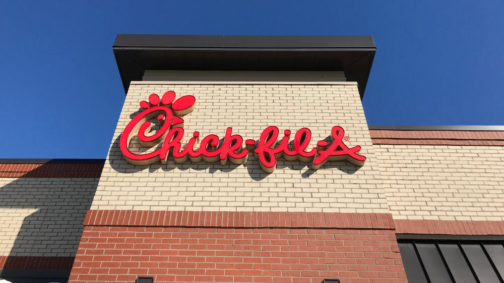 A Chick fil-A logo sits atop one of its restaurant buildings.