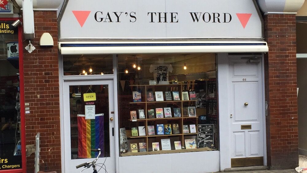 Gay's The Word is a gay bookstore whose sign has pink triangles and a rainbow flag in his glass front door.