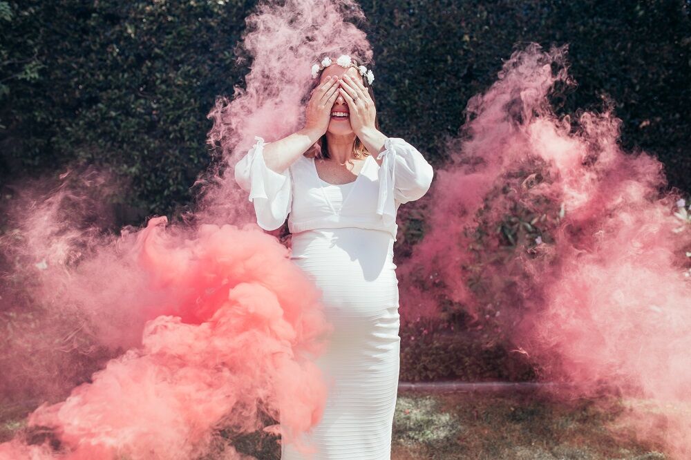 Gender reveal party with pink smoke