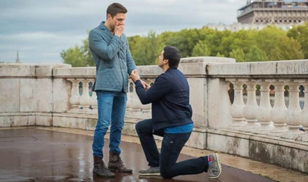 Gio Benitez proposes to Tommy DiDario near the Eiffel Tower.