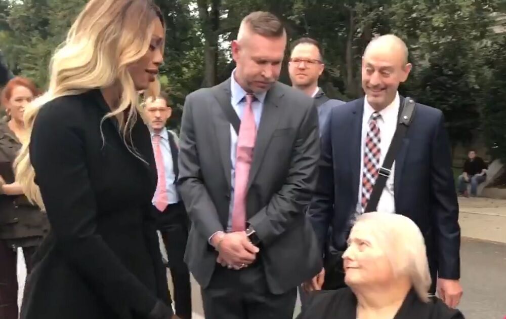 Actress Laverne Cox greets Aimee Stephens, who was fired from her job at a funeral home when she announced her transition. Her former employers say they are allowed to fire trans people because federal law doesn't protect them.