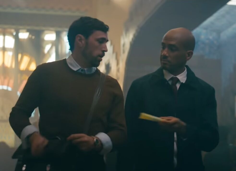 One man hands another a tampon in the Thinx ad.