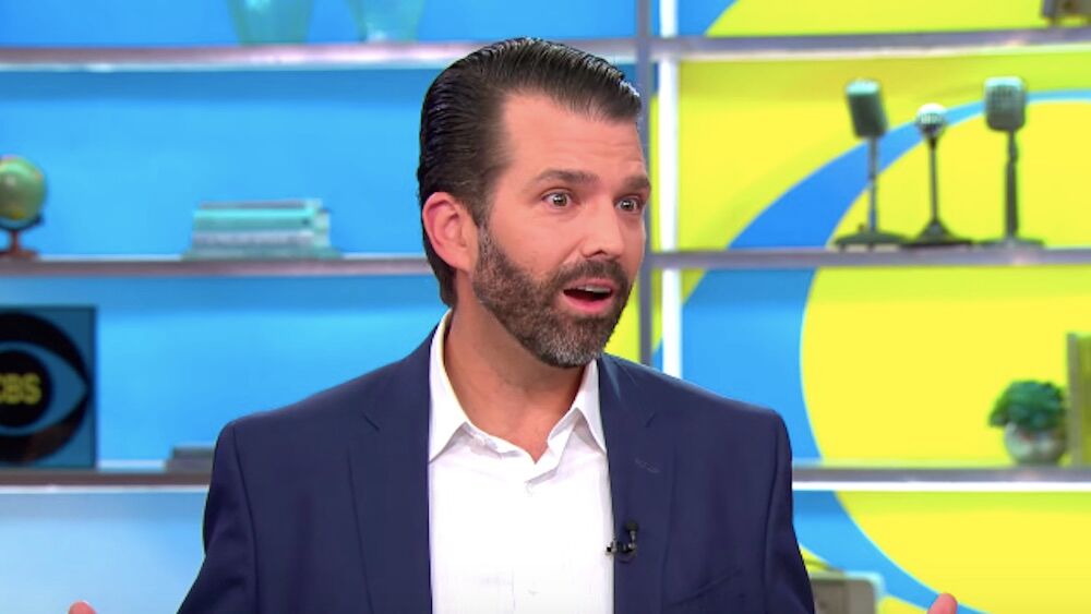 Donald Trump Jr. is a balding white man with facial scruff in a blue blazer on a morning talk show.