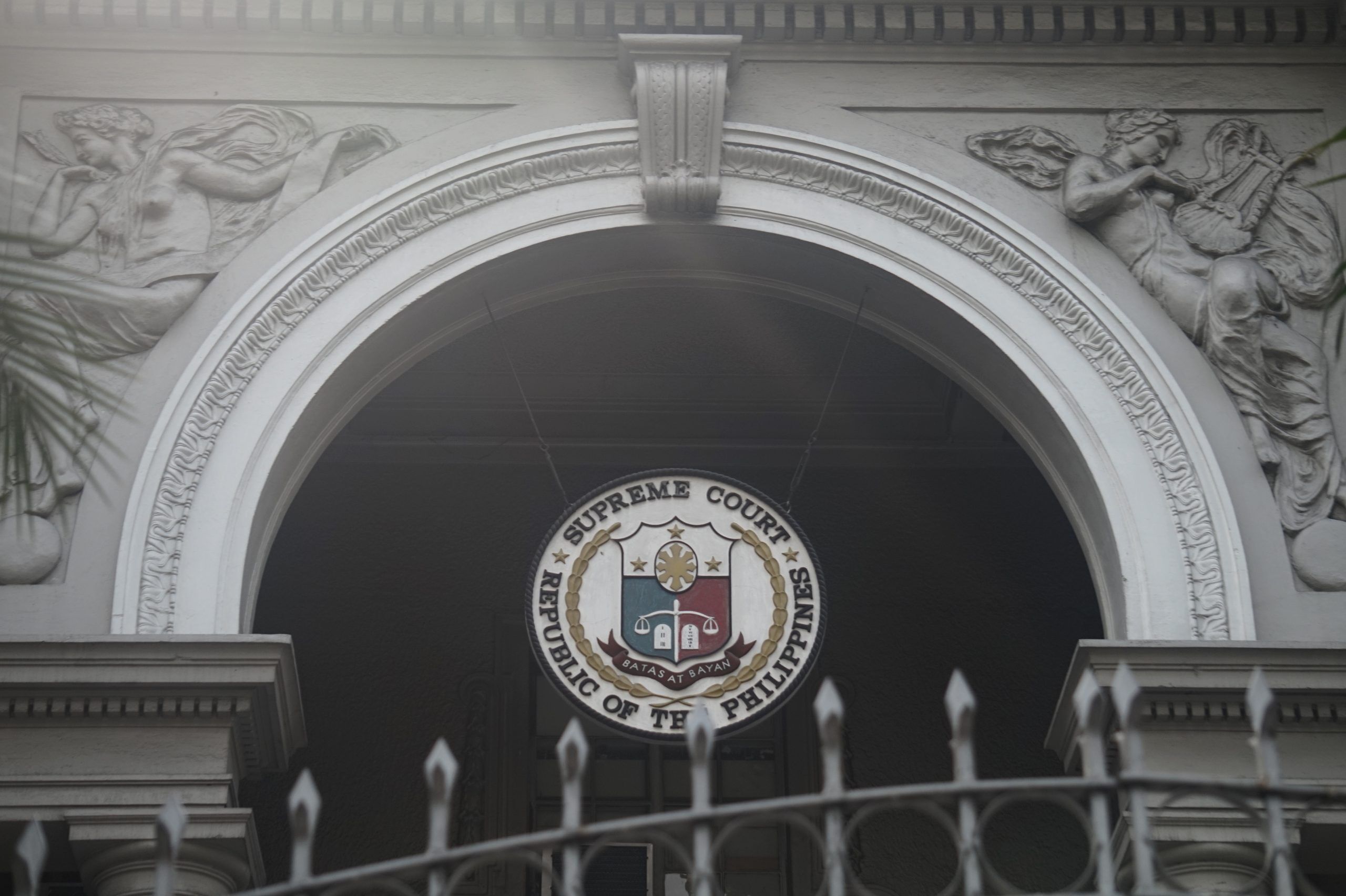 Manila, Philippines; February 6, 2018: An arched entrance in the old Supreme Court Building found along Taft Avenue. Bas relief figures of muses adorn each side.