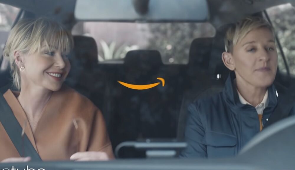 Ellen and Portia in a car with the Amazon "smile" logo