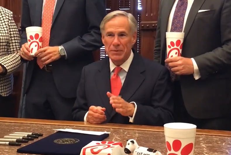 Texas Governor Greg Abbott surrounded himself with fast food sandwiches to sign the "Save Chick-fil-A" bill into law.