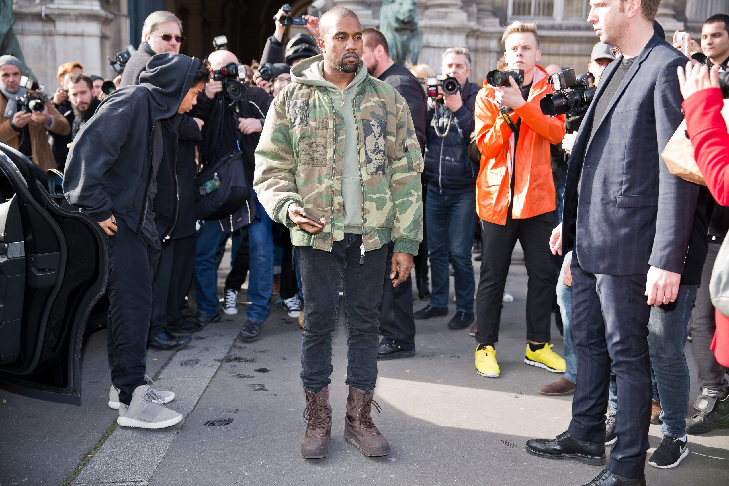 PARIS-MARCH 4, 2015. Kanye West posing for photographers in front of the Dries van Noten fashion show.
