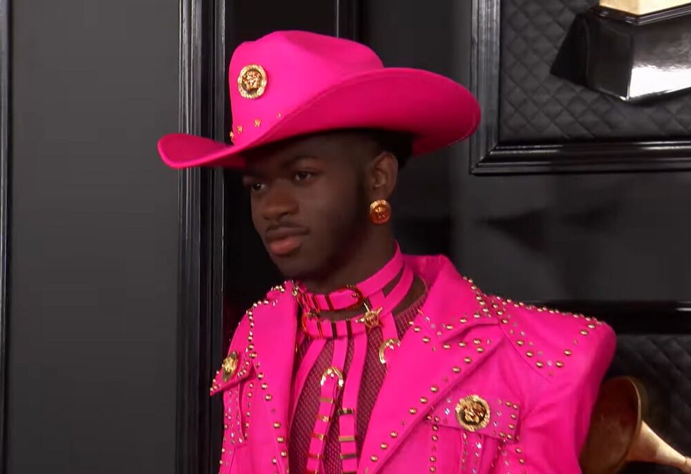 Lil Nas X in a pink leather cowboy ensemble