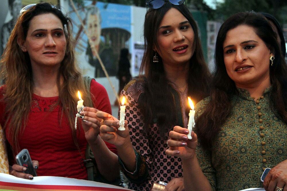 Transgender women in Pakistan holding candles