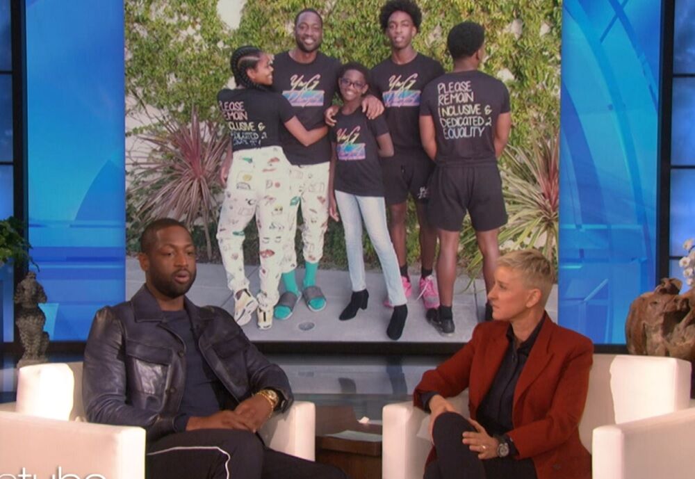 Dwyane Wade on Ellen's show in front of a photo of his family at Pride.