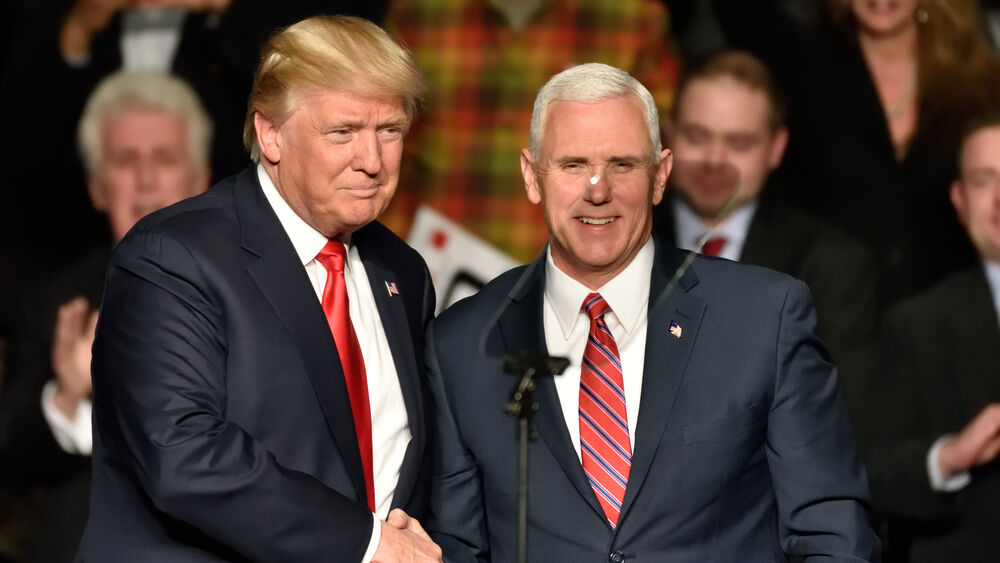 Donald Trump shakes Mike Pence's hand, and has also named him in charge of handling a possible Coronavirus outbreak in the U.S.